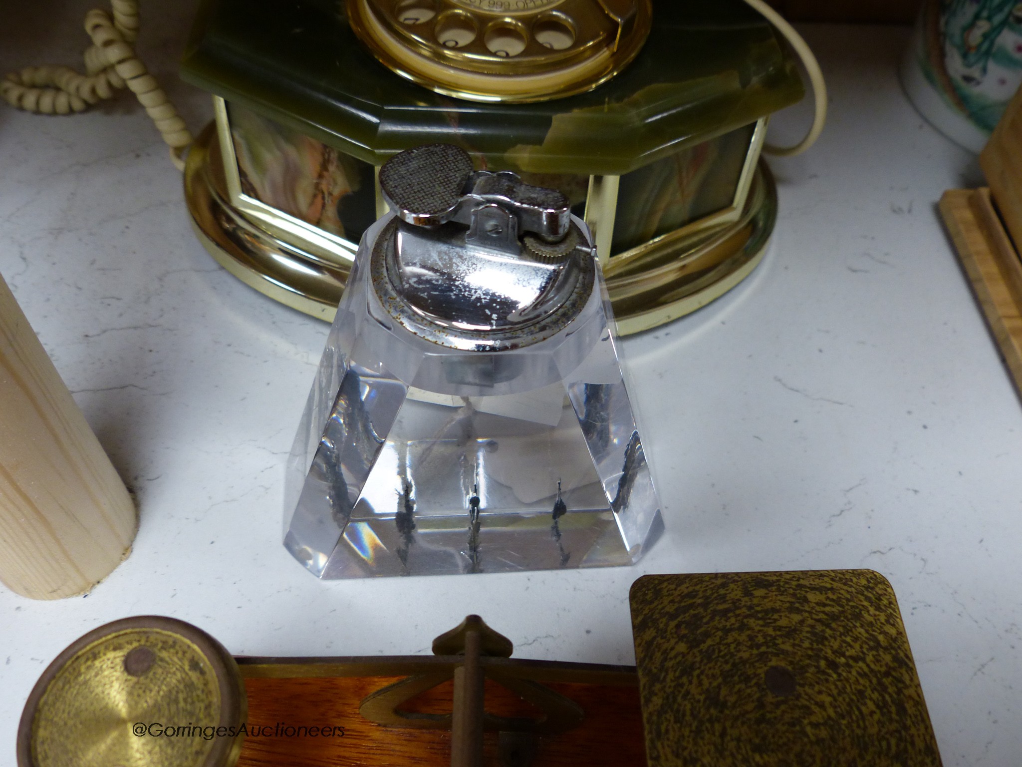 A pair of brass letter scales, a 1960's plastic table top lighter and an onyx telephone